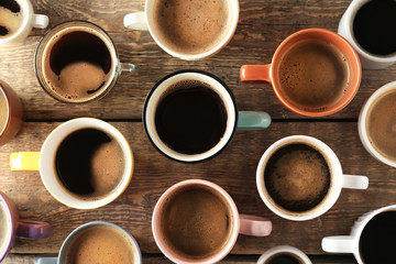 Lots of coffee cups on wooden background