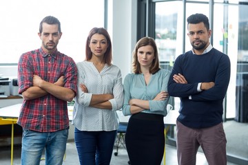 Portrait of businesspeople standing with arms crossed