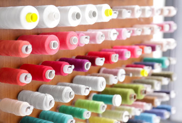Spools with threads on rack, closeup