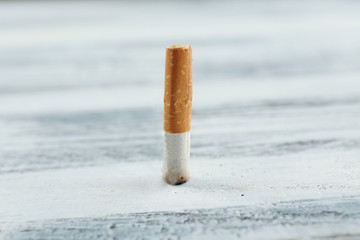 Cigarette butt on wooden background