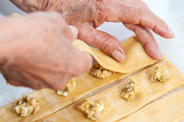 Ravioli Preparation : Placing the upper dough strip to seal the ravioli