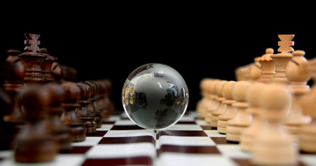 Chess figures against earth globe