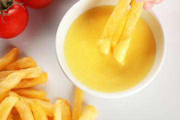 Delicious french fries with cheese sauce, closeup