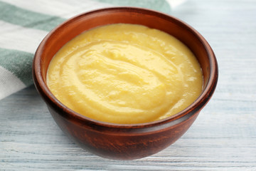 Bowl with delicious cheese sauce, closeup