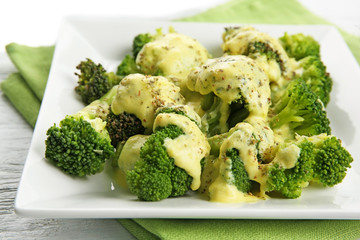 White plate of delicious broccoli with cheese cream, closeup
