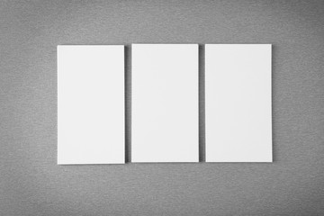Blank paper cards for branding on grey background