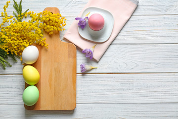 Beautiful Easter composition with cutting board on wooden background