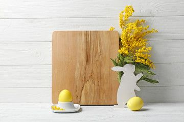 Beautiful Easter composition with cutting board on wooden table