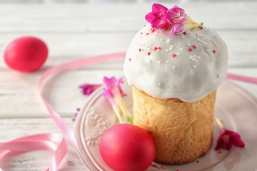 Easter cake and egg on white plate decorated with flowers