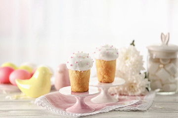 Stands with Easter cakes on blurred background