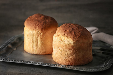 Delicious Easter cakes on tray against grey background