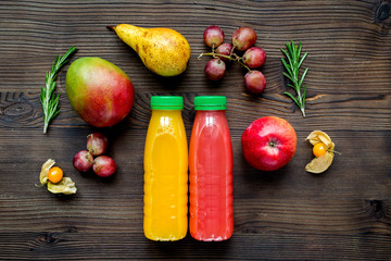 multifruit drink in plastic bottle on wooden background top view mock up