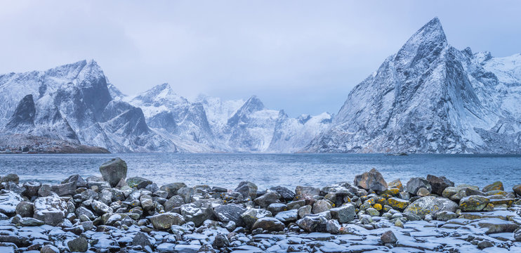 Winter mountains panorama view with stones at foreground