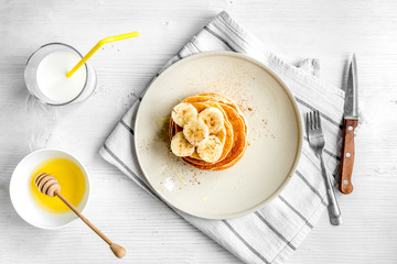 cooked pancake on plate top view at wooden background