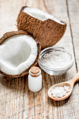 Fototapeta na wymiar fresh coconut with cosmetic oil in jar on wooden background