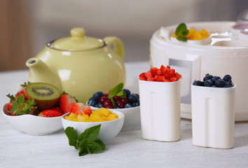 Composition with tasty homemade yogurt and ingredients on light wooden table
