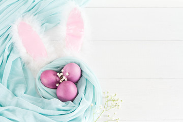 Colorful easter eggs  on a white wooden background. Space for text. Top view