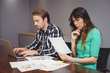 Male and graphic designers working together in conference room