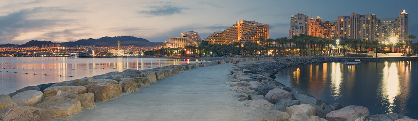 Night view on central public beach of Eilat from stone pier. Eilat is a number one resort city in Israel