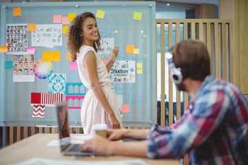 Female graphic designer interacting with her colleague