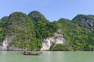 Beautiful Island with longtail boat in Phang Nga Bay