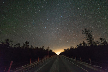Highway in the winter at night with stars