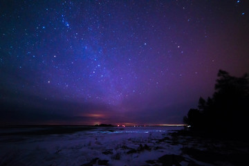 Naklejka na ściany i meble Milky way over Lake Huron in Winter on the Bruce Peninsula