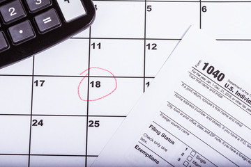 1040 tax return with calender and the 18th circled in red