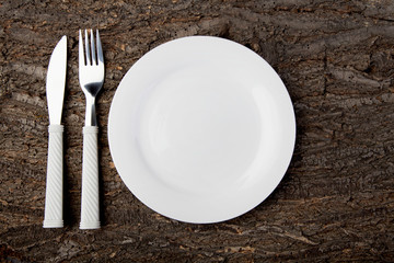 Plate white fork knife empty wooden table top view