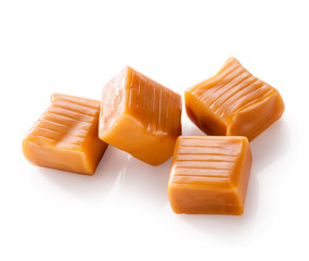 Four square pieces toffee caramel close-up isolated on white background (with clipping path)
