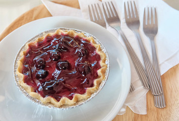 Good morning with strawberry cheese cake and any fork on white dish. (Top View)