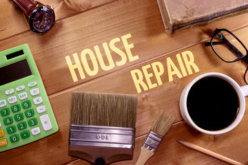 Paint brush, calculator, watch, glasses and coffee cup with inscription House repair