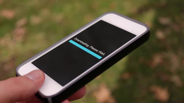 A smartphone downloading files over Wi-Fi in an outdoor environment