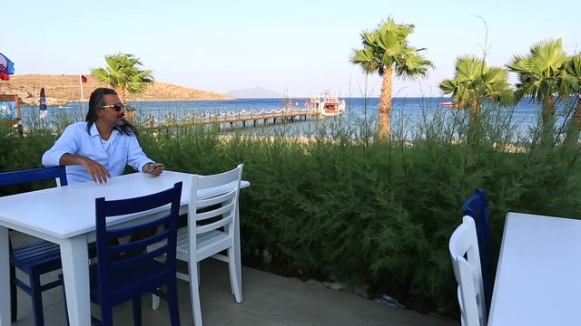 attractive brunette man waiting in cafe