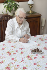 Staruszka pisze odręcznie testament. - obrazy, fototapety, plakaty
