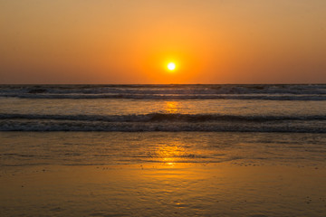 Fototapeta premium Sunset over Arabian sea, Indian ocean, on Arambol beach, Goa, India