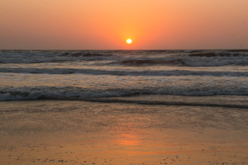 Sunset over Arabian sea, Indian ocean, on Arambol beach, Goa, India