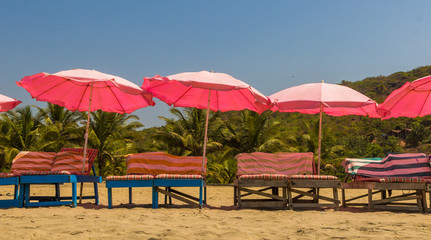 Beach chairs and with umbrella on the beach near Sweet lake, Arambol beach, North Goa