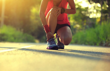 young fitness woman runner got sports injury on knee and legs