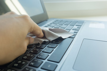 woman hands cleaning laptop computer screen by towel.