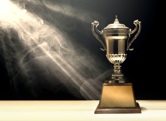 silver trophy placed on wooden table with dark background copy space ready for your design win...