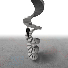 Businessman climbing concrete spiral staircase