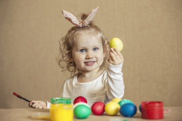 Small cute baby color Easter eggs on the table in colours, happy Easter!