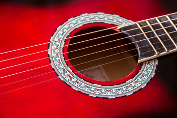 Obraz premium Part of red acoustic guitar. Close up