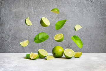 Limes and flying slices and leaves, copy space