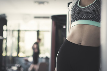 fitness woman doing exercises and warm up at gym ; healthy lifestyle