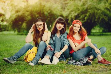 Fototapeta premium three young girls walking in the park