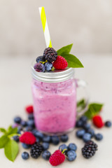 Delicious berry smoothie made with fresh ingredients on light background. Healthy diet.