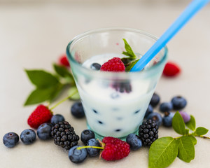 Yogurt with fresh berries fruit and crispy wafers on stone background. 