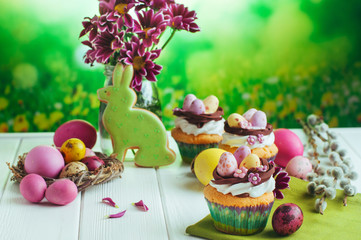 Closeup of Easter cupcakes on white wooden background